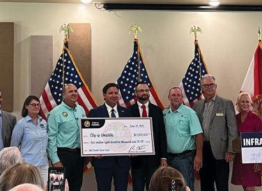 Governer Ron DeSantis presenting a check to the City of Umatilla with Halff in June 2024 for grant funding